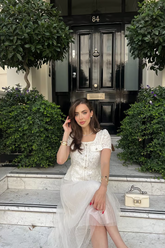 a lady in a square neck patchwork dress